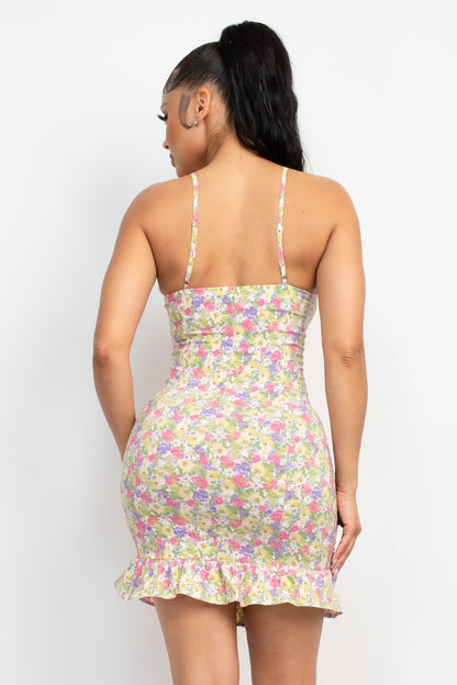 Woman wearing a floral dress with thin straps on a white background