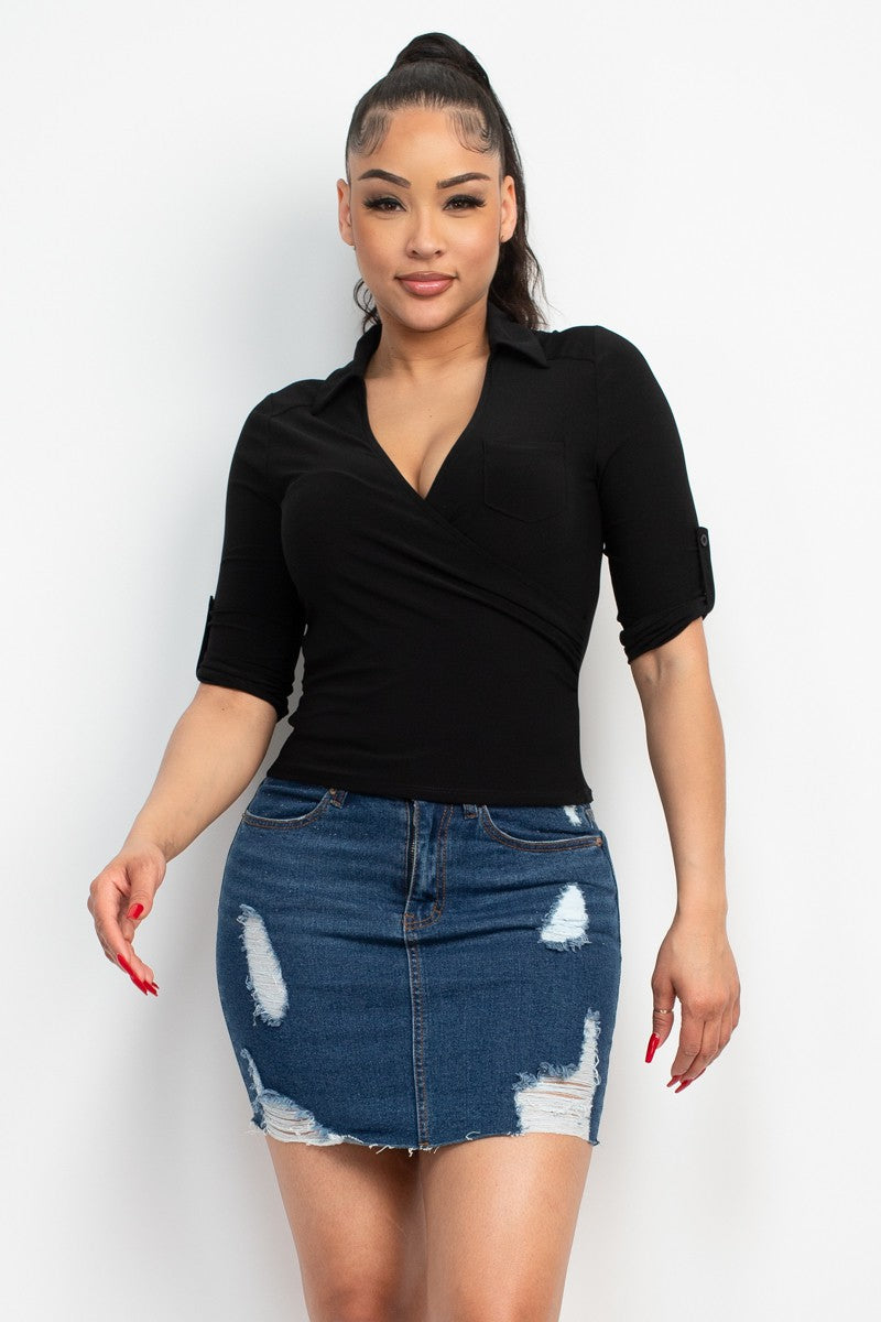 Woman wearing a black top and denim skirt on a white background
