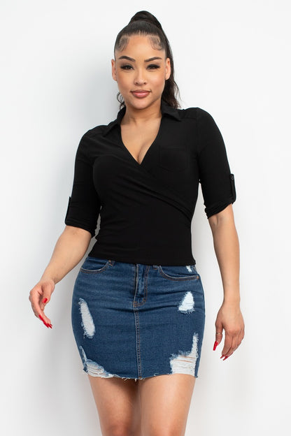 Woman wearing a black top and denim skirt on a white background