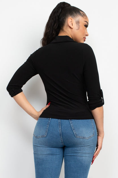 Person wearing a black long-sleeve top and blue jeans on a white background
