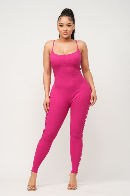 Woman wearing a fuchsia pink jumpsuit on a white background