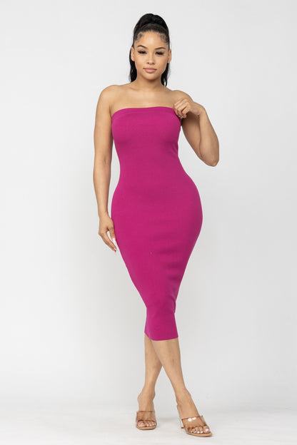 Woman wearing a strapless magenta pink dress on a white background