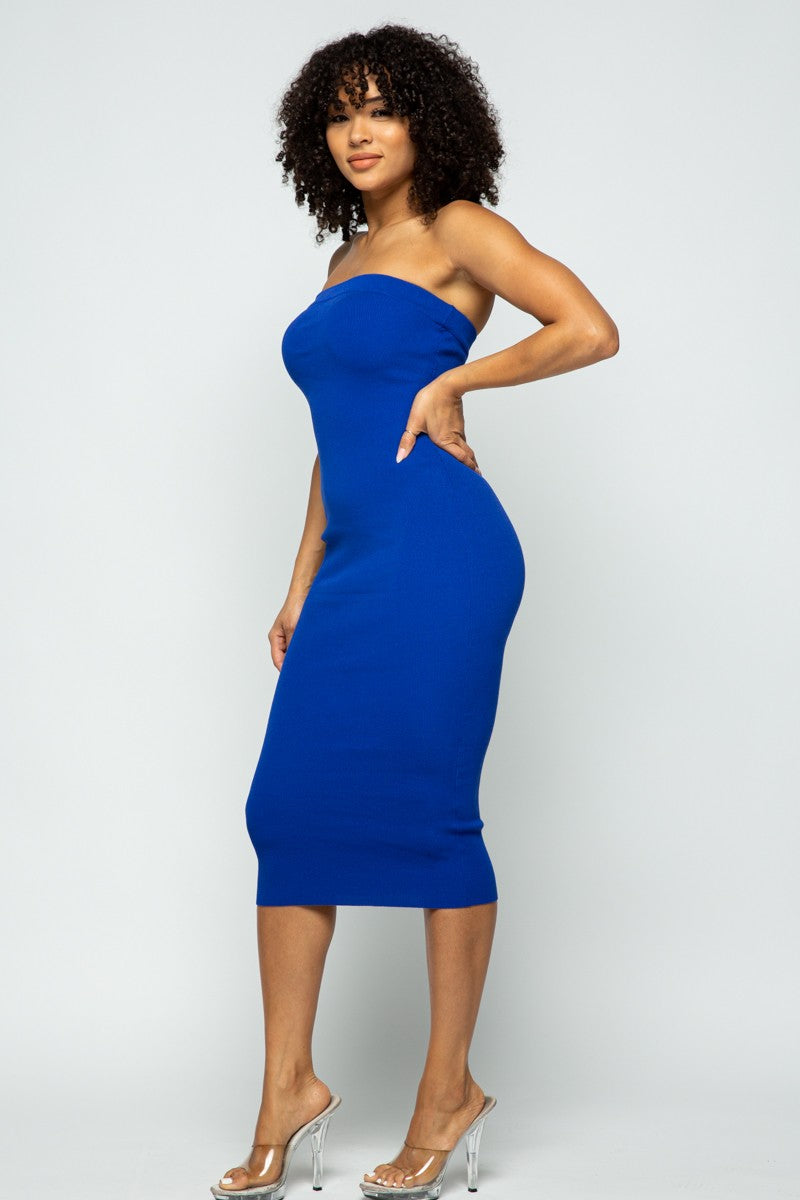 Woman wearing a royal blue strapless dress against a white background