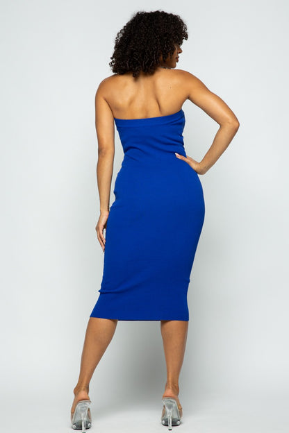 Woman wearing a royal blue strapless dress against a white background