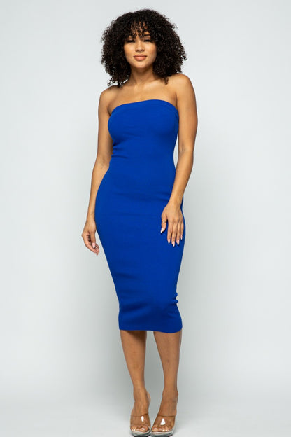 Woman wearing a royal blue strapless dress against a white background