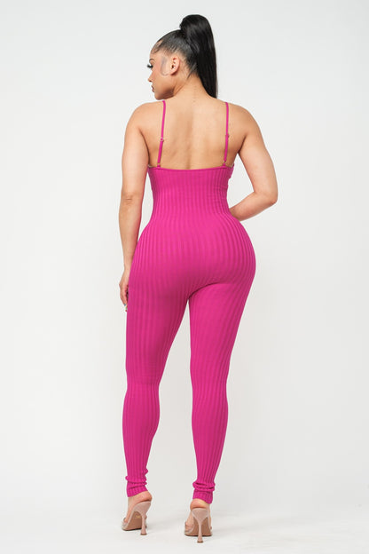 Woman wearing a fuchsia pink jumpsuit on a white background