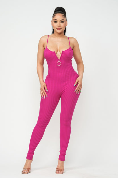 Woman wearing a fuchsia pink jumpsuit on a white background