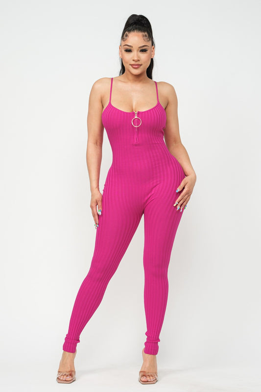 Woman wearing a fuchsia pink jumpsuit on a white background