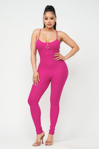 Woman wearing a fuchsia pink jumpsuit on a white background