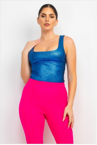 Woman wearing a blue top and pink pants on a white background