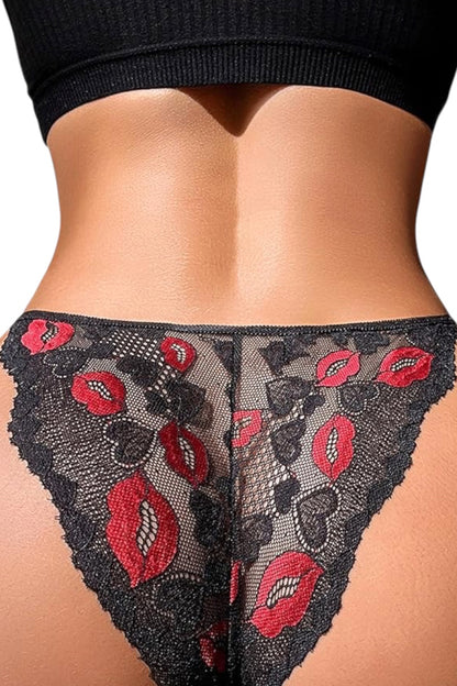 Black lace thong with red lip applique, shown on a model's lower back and hips against a white background.