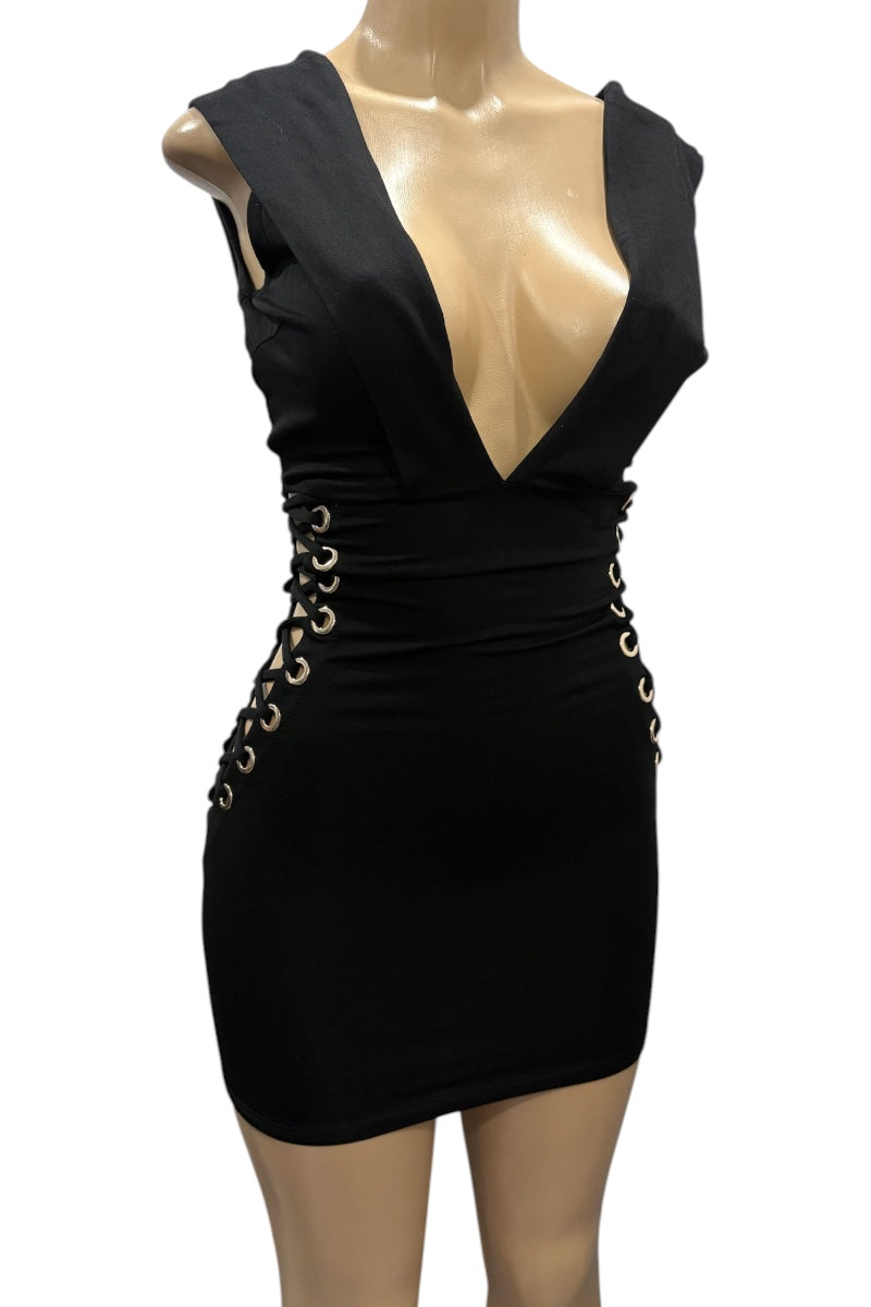 Black dress with gold embellishments on a mannequin against a white background