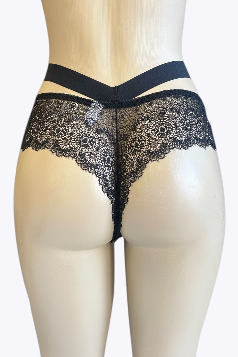 Black lace underwear on a mannequin against a white background