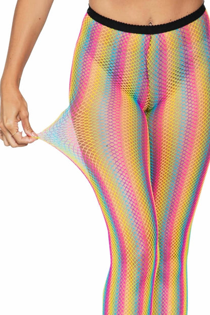 A close-up of a person wearing rainbow-striped fishnet leggings with a black waistband, pulling the fabric at the side to show stretch, against a plain white background.