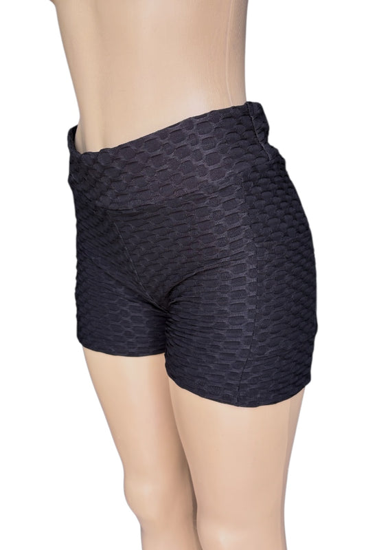 Black patterned shorts worn by a mannequin on a white background