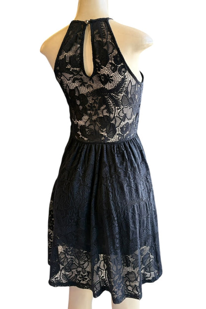 Black lace dress on a mannequin against a white background