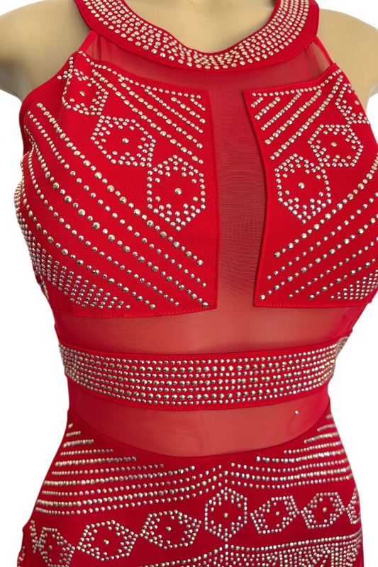 Red dress with white embellishments on a mannequin against a white background