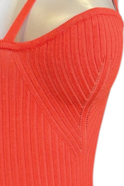 Close-up of a ribbed knit top in a bright coral-orange color, shown on a mannequin torso against a white background.