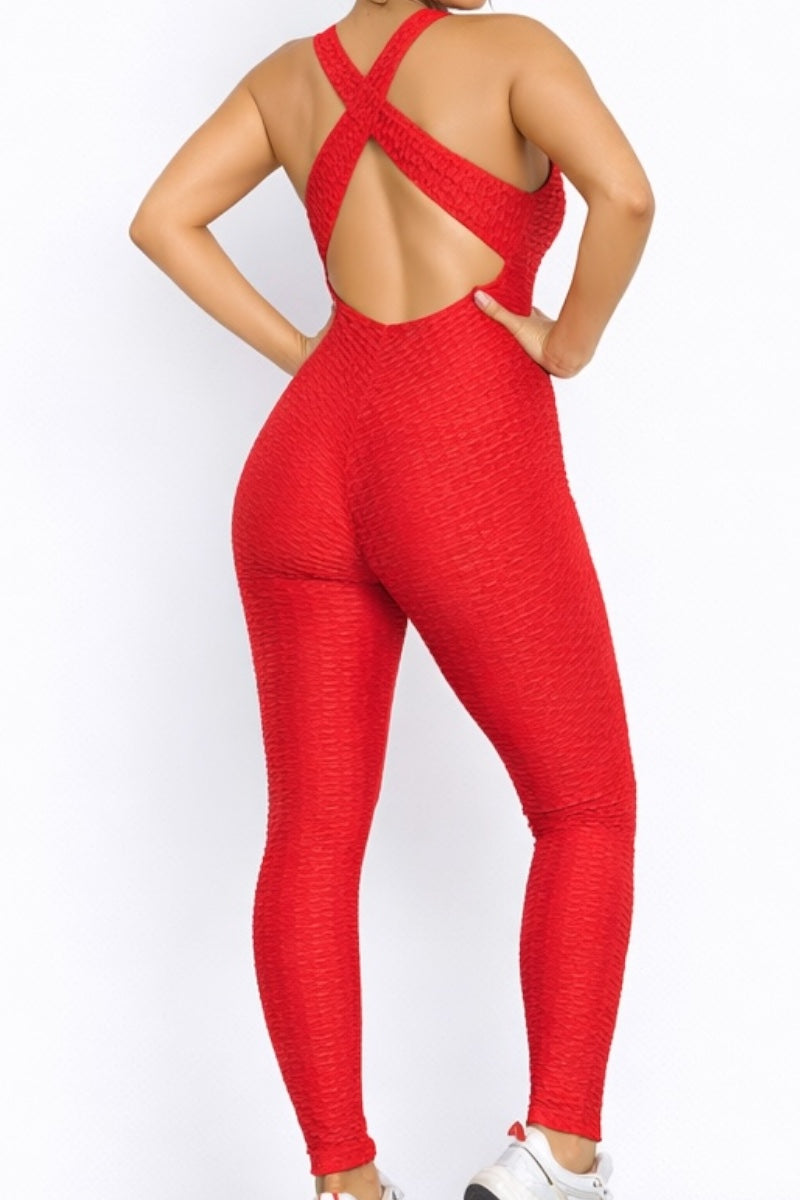 Red open-back jumpsuit worn by a person on a white background