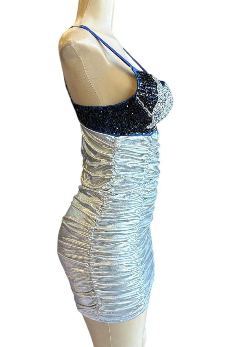 Mannequin wearing a silver and blue dress with sequin details on a white background