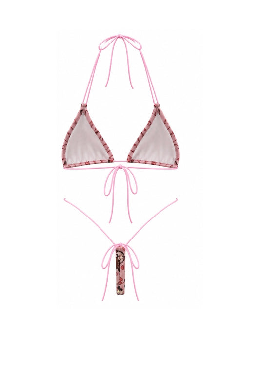Pink string bikini set with a  patterned trim, featuring a triangle top with halter necklines and a matching low-rise g-string bottom with a tie at the center.