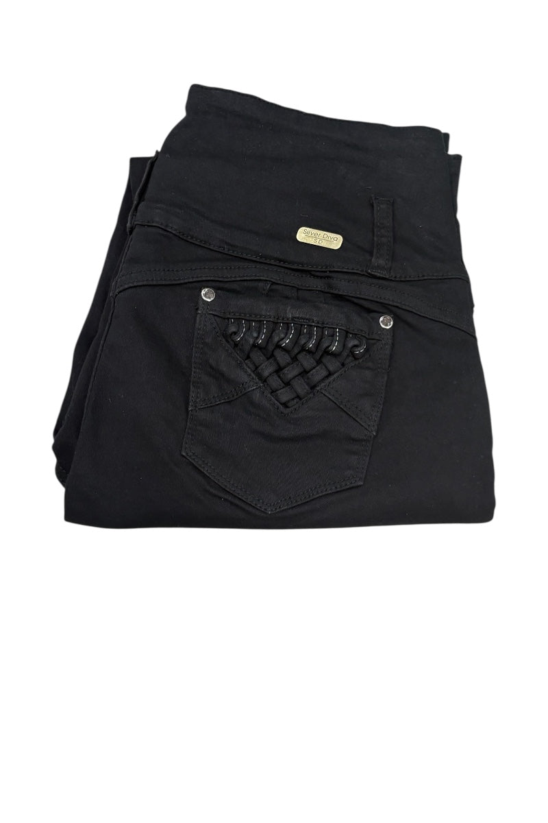 Black denim jeans folded to show the back pocket with a decorative woven patch and a small gold-tone brand plaque, on a white background.