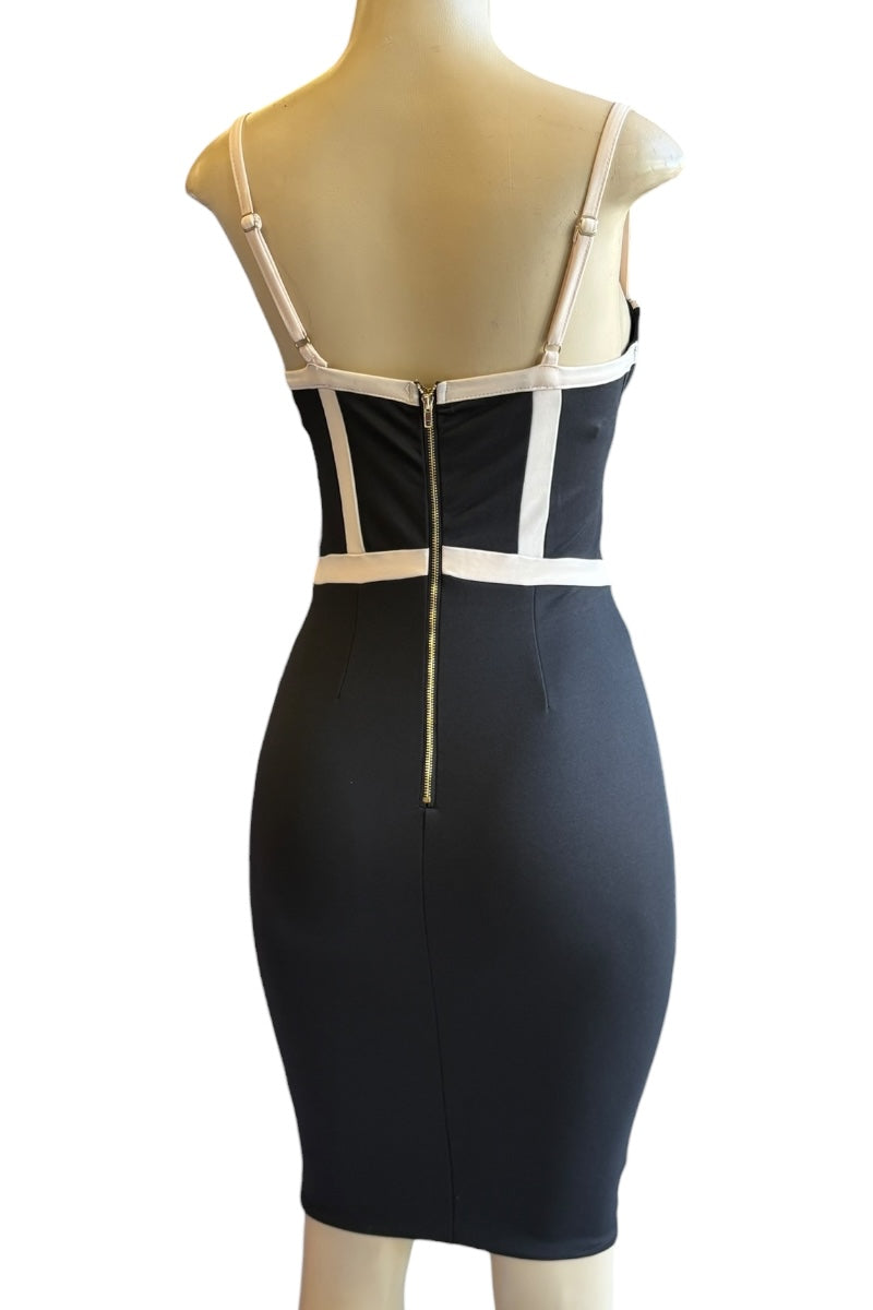 Black dress with beige accents on a mannequin against a white background