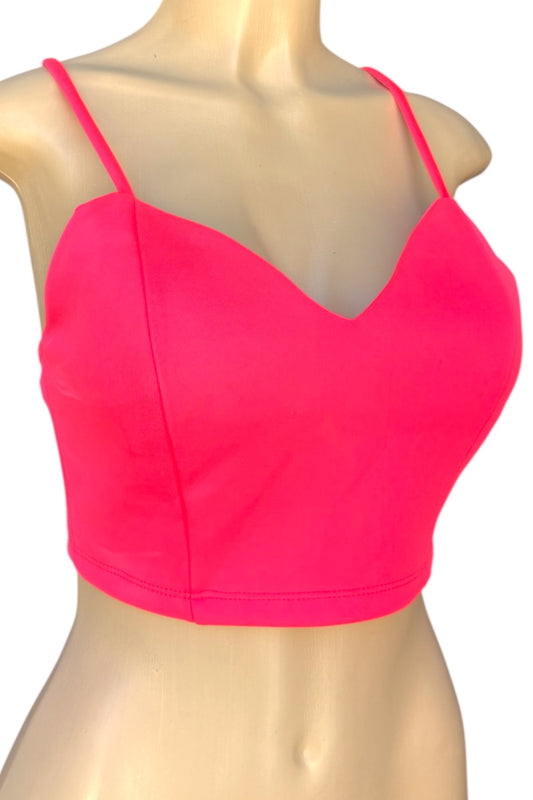 Neon pink crop top on a mannequin with a white background