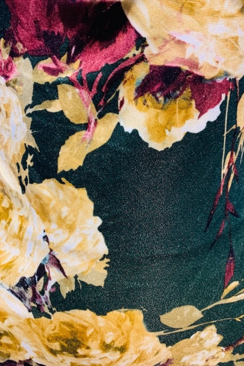 Close-up of a floral pattern with yellow and red flowers on a dark background