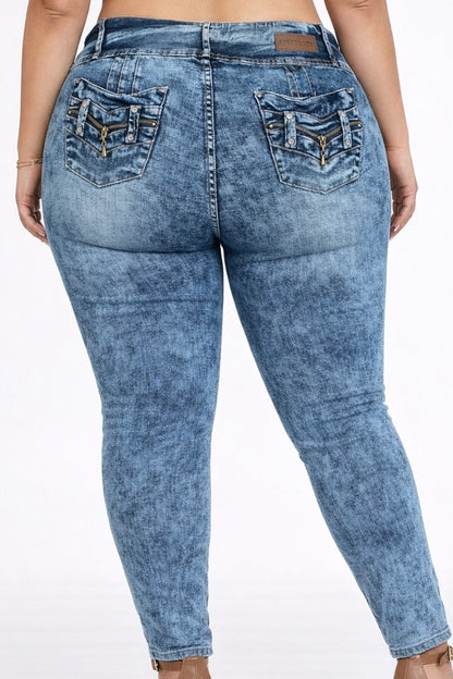 Blue acid-wash jeans worn by a person on a white background