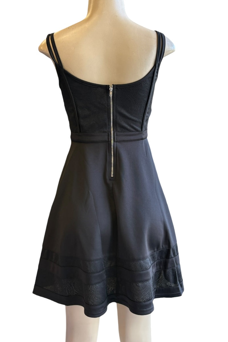 Black dress with a zipper on a mannequin against a white background