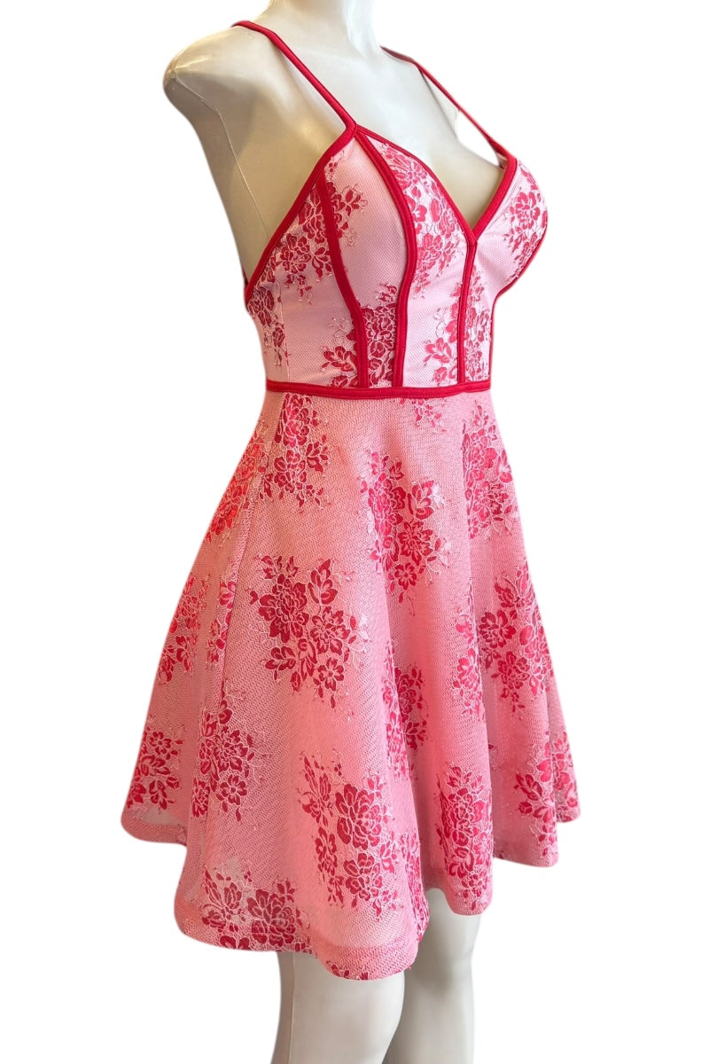 red lace dress on a mannequin against a white background