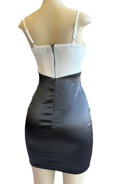 Mannequin wearing a two-tone dress with white top and black skirt on a white background
