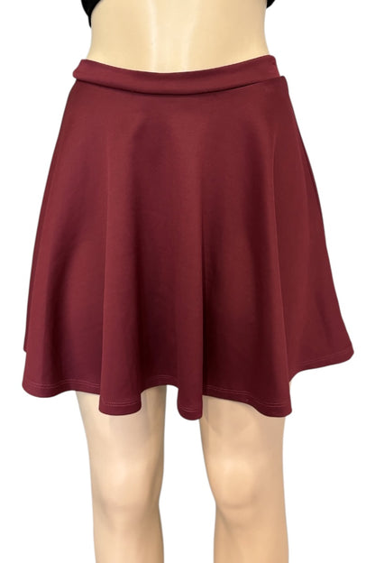 A dark burgundy flared mini skirt displayed on a beige mannequin torso and legs against a plain white background.