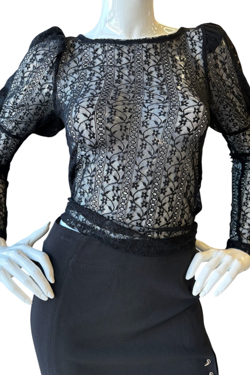 Mannequin wearing a black lace top and black skirt on a white background