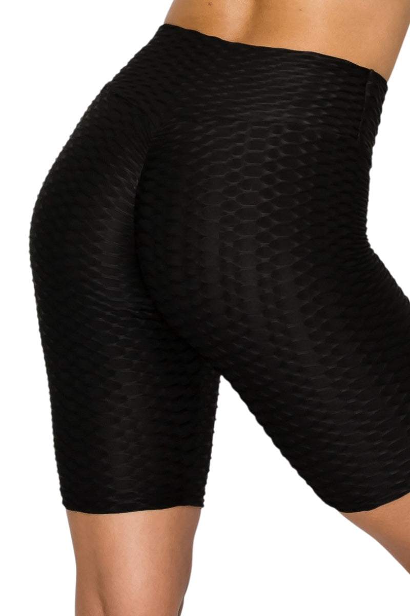 Black textured biker shorts on a white background