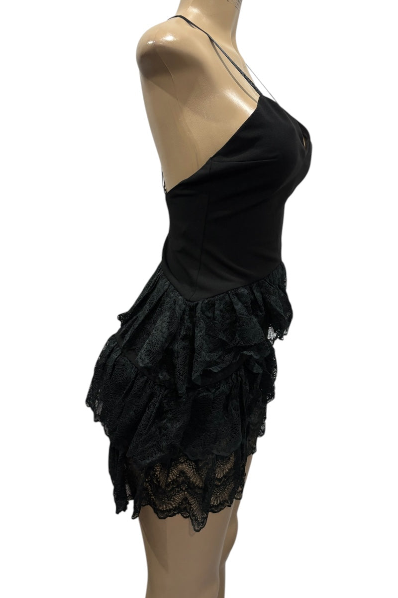 Black lace dress on a mannequin against a white background