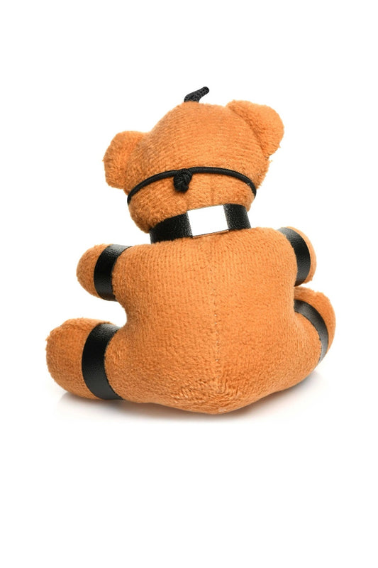 Plush toy with black straps on a white background