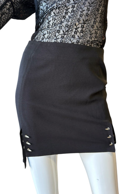 Black skirt with silver details on a mannequin against a white background