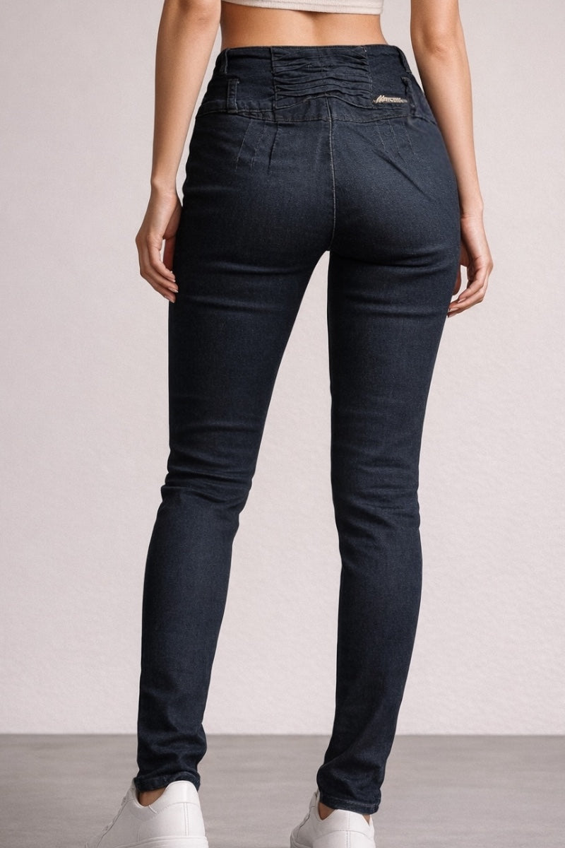 Person wearing black jeans on a plain background
