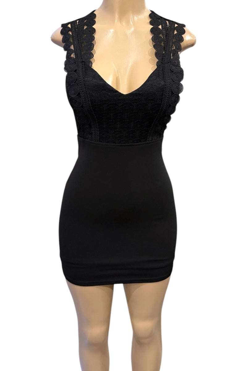 Black dress with lace details on a mannequin against a white background