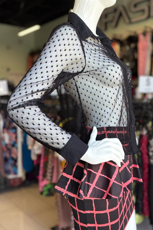 Mannequin wearing a black polka dot top with a red and black checkered skirt in a store setting.