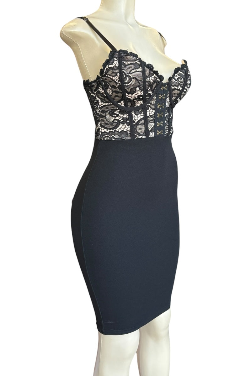 Black lace dress on a mannequin against a white background