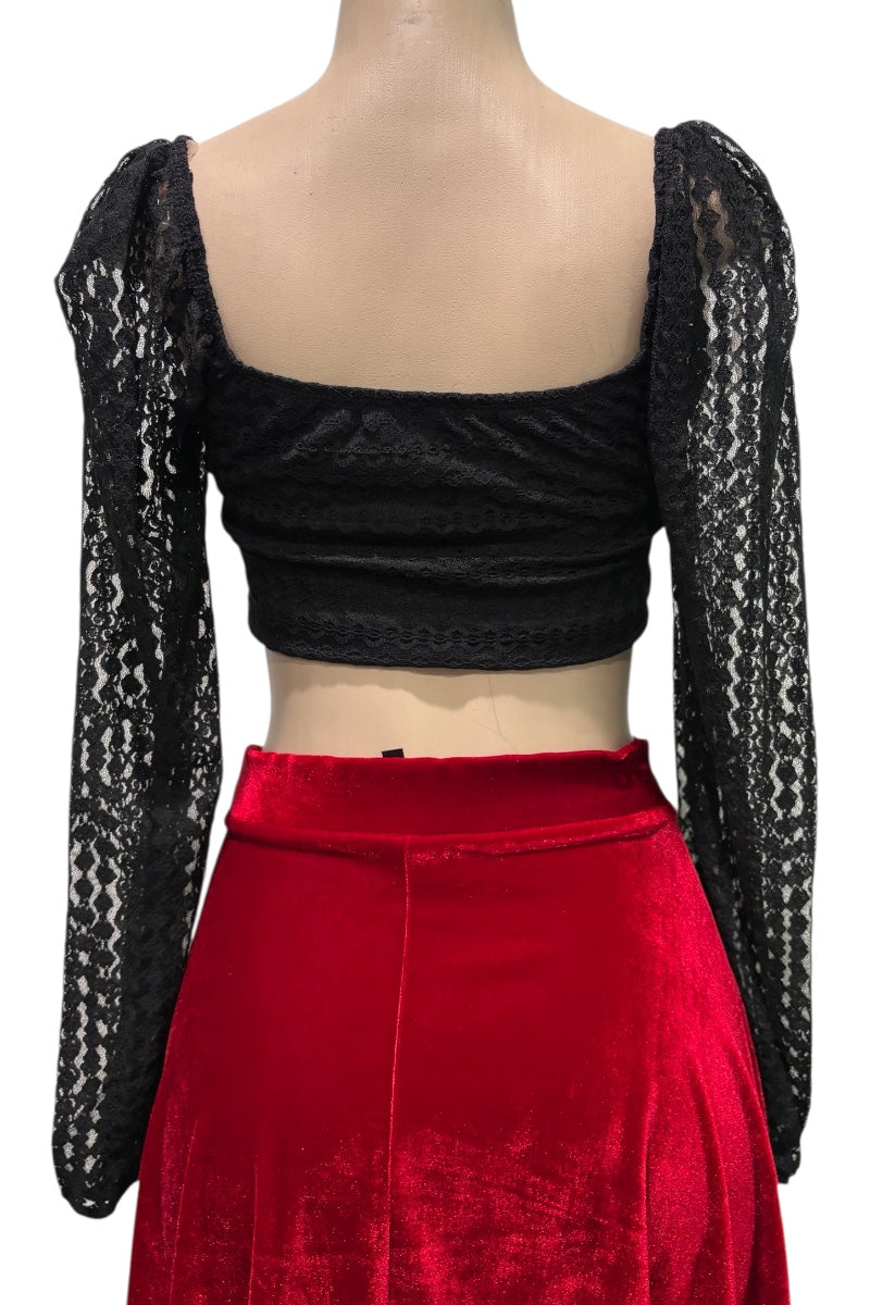 Black lace top with long sleeves and red skirt on a white background