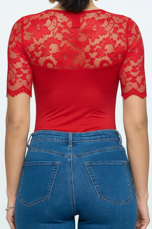 Red lace top and blue jeans on a white background