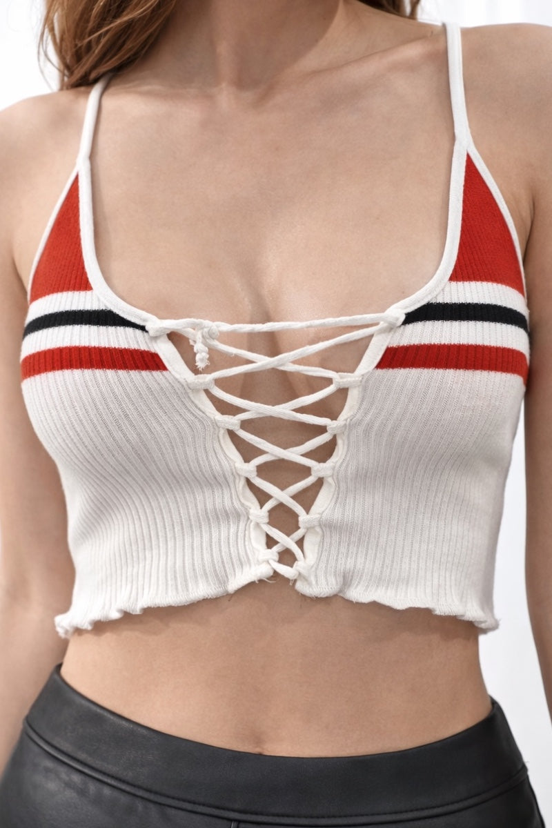 White crop top with red and black stripes and lace-up front on a white background