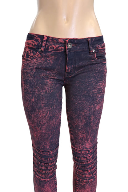 Red and black distressed jeans on a mannequin against a white background