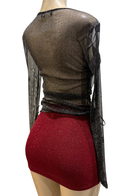Mannequin wearing a sheer black top with red skirt on a white background