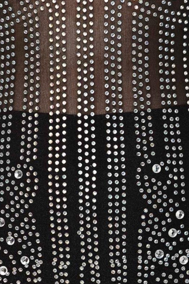 Close-up of a fabric with rhinestone embellishments on a black background