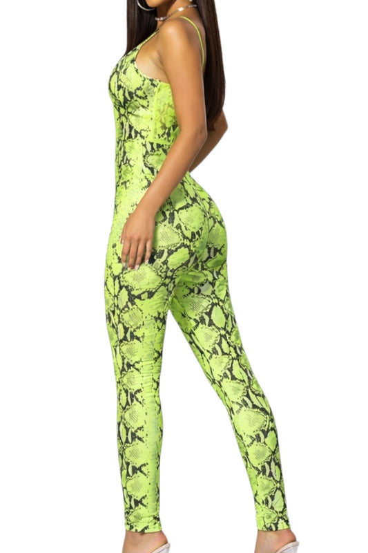 Person wearing a bright green snake print jumpsuit on a white background